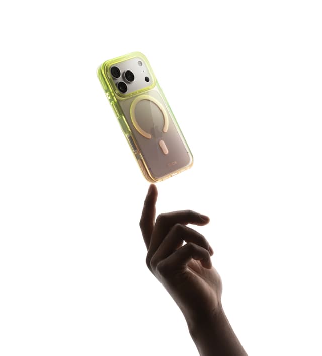 CLICK Clear Ombre case with a green-to-gold tint floating above an outstretched hand, camera cutout and MagSafe ring visible