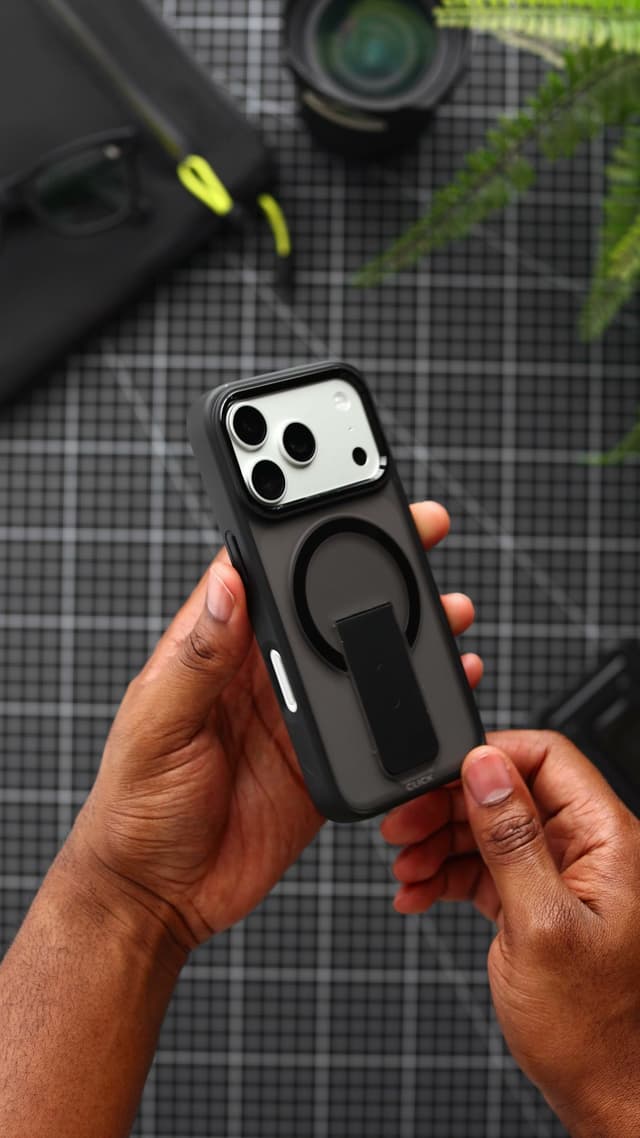 The back of an iPhone 17 Pro in a black CLICK Latch Holster case, with the magnet ring and the kickstand folded flat inside it
